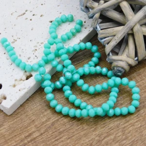 Oponki fasetowane ze szkła 4.5x3.5mm jasne turkusowe z perłowym połyskiem (110szt.)