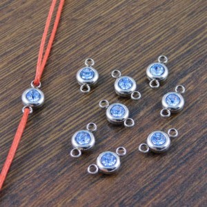 Łącznik stal chirurgiczna z jasno niebieską cyrkonią 12x6.5mm ciemne srebro (1szt.)